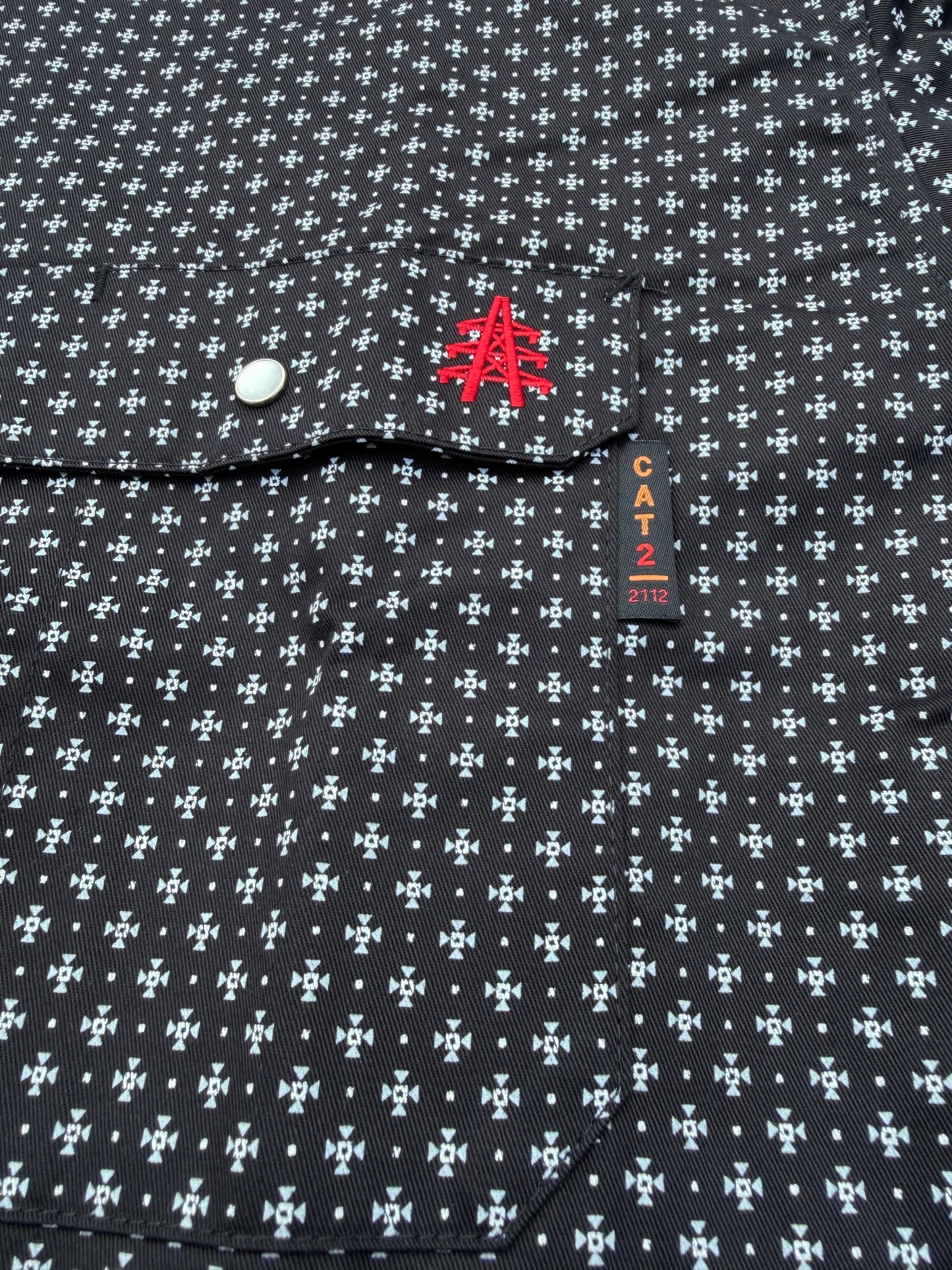 Static FR Pearl Snap Work Shirt Reaper Black with white microprint pattern, chest pocket with silver snap and red embroidery, CAT 2 tag visible on Tampa Home & Garden Store