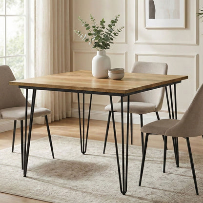 Square mango wood dining table with black hairpin legs in a neutral dining room on Tampa Home & Garden Store