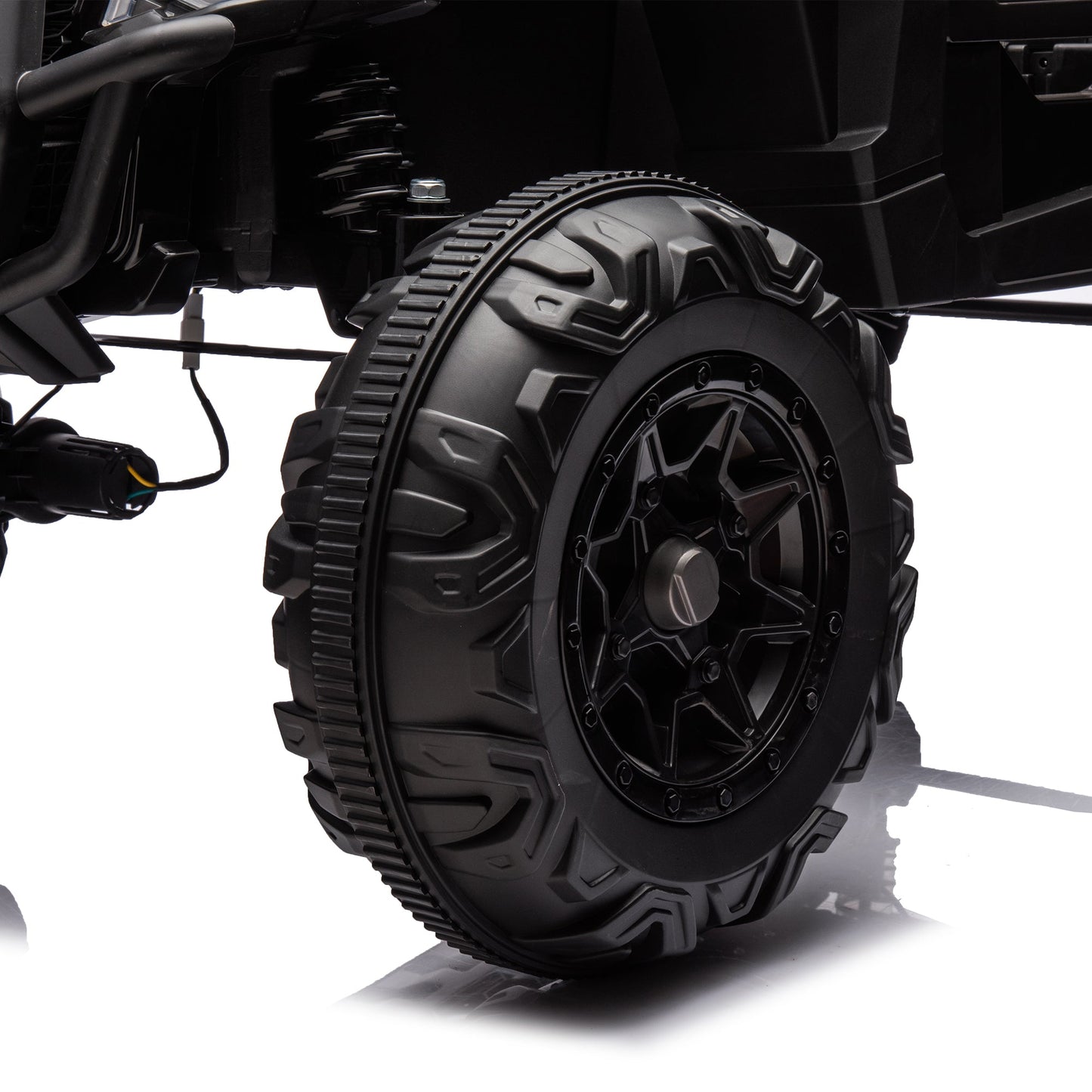 Side by Side 4x4 ride-on off-road truck tire close-up with rugged tread and suspension on Tampa Home & Garden Store