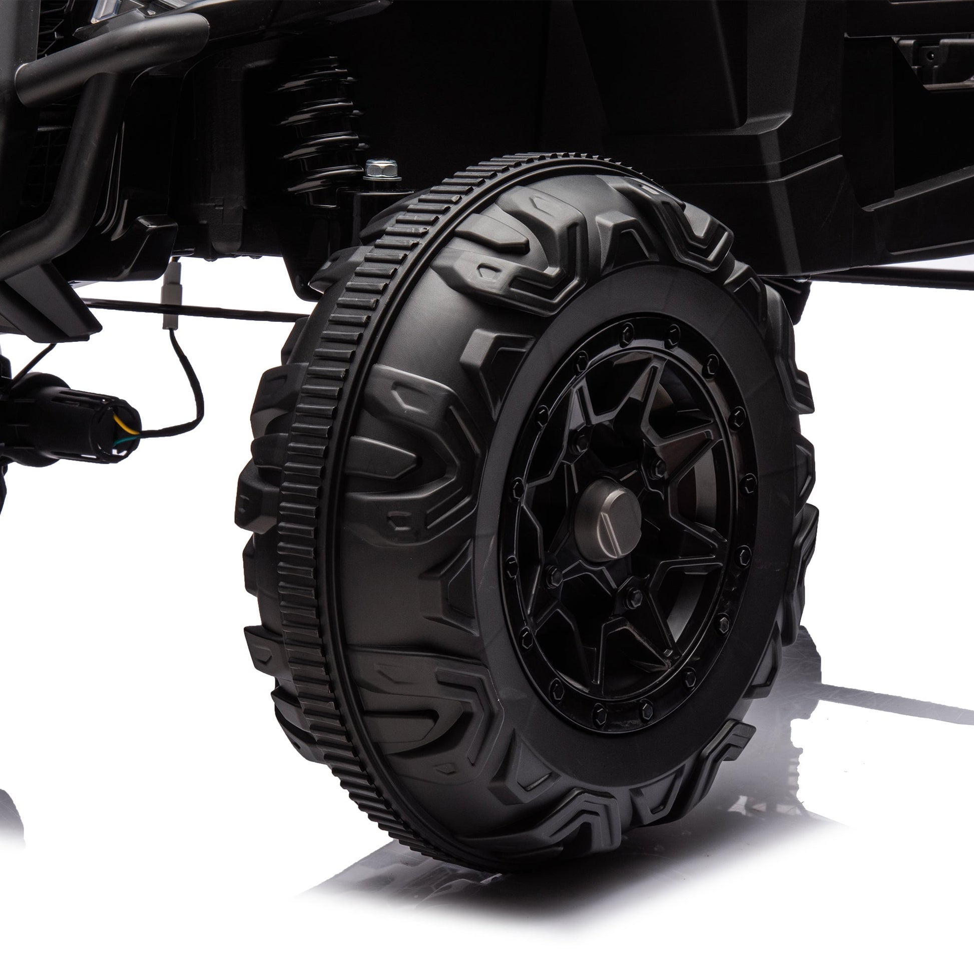 Side by Side 4x4 ride-on off-road truck tire close-up with rugged tread and suspension on Tampa Home & Garden Store