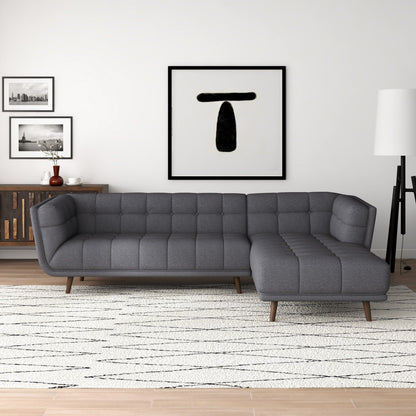 L-shaped tufted sectional sofa in dark gray with mid-century modern legs on Tampa Home & Garden Store