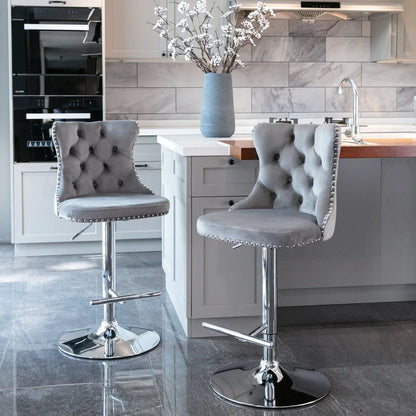Set of 2 gray tufted swivel bar stools with backs and chrome bases at island on Tampa Home & Garden Store