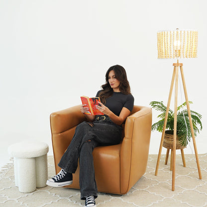 Tan genuine leather swivel chair with adjustable headrest; modern armchair setup on Tampa Home & Garden Store