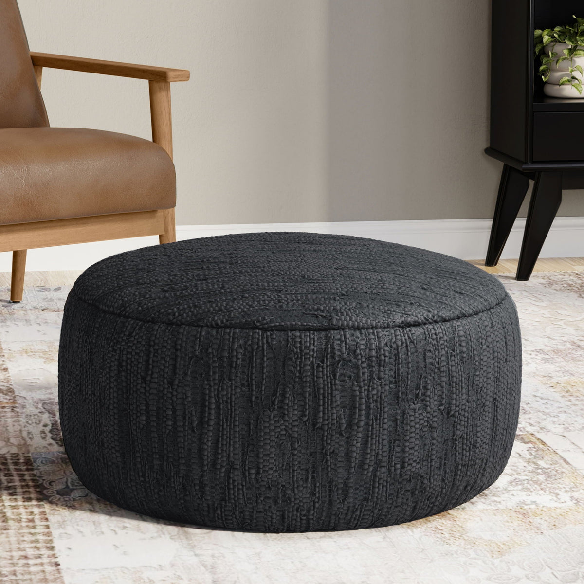 Black leather round pouf Fredrik by HouseOfZazla with dense bead support, woven texture on Tampa Home & Garden Store
