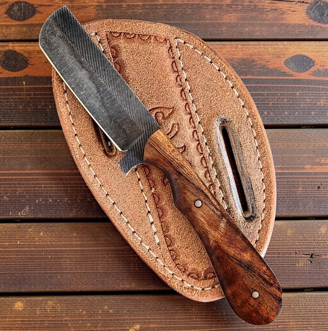 The Wrangler bull cutter knife with rasp steel blade and natural wood handle in leather sheath on Tampa Home & Garden Store