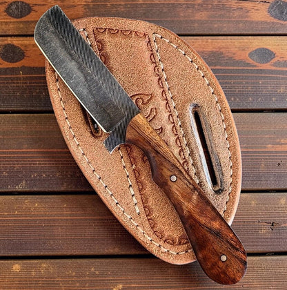 The Wrangler bull cutter knife with rasp steel blade and natural wood handle in leather sheath on Tampa Home & Garden Store