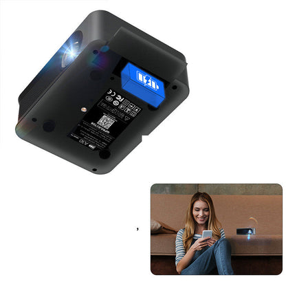 Portable wireless HD compact projector; black body with blue battery module; living room projection on Tampa Home & Garden Store