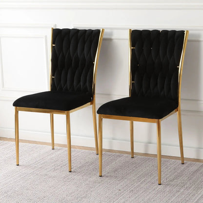 Pair of modern dining chairs with black tufted velvet backs and seats, gold frames on Tampa Home & Garden Store