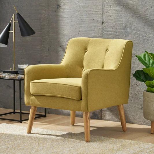Yellow fabric arm chair with light wooden legs in a modern living room beside brass floor lamp on Tampa Home & Garden Store