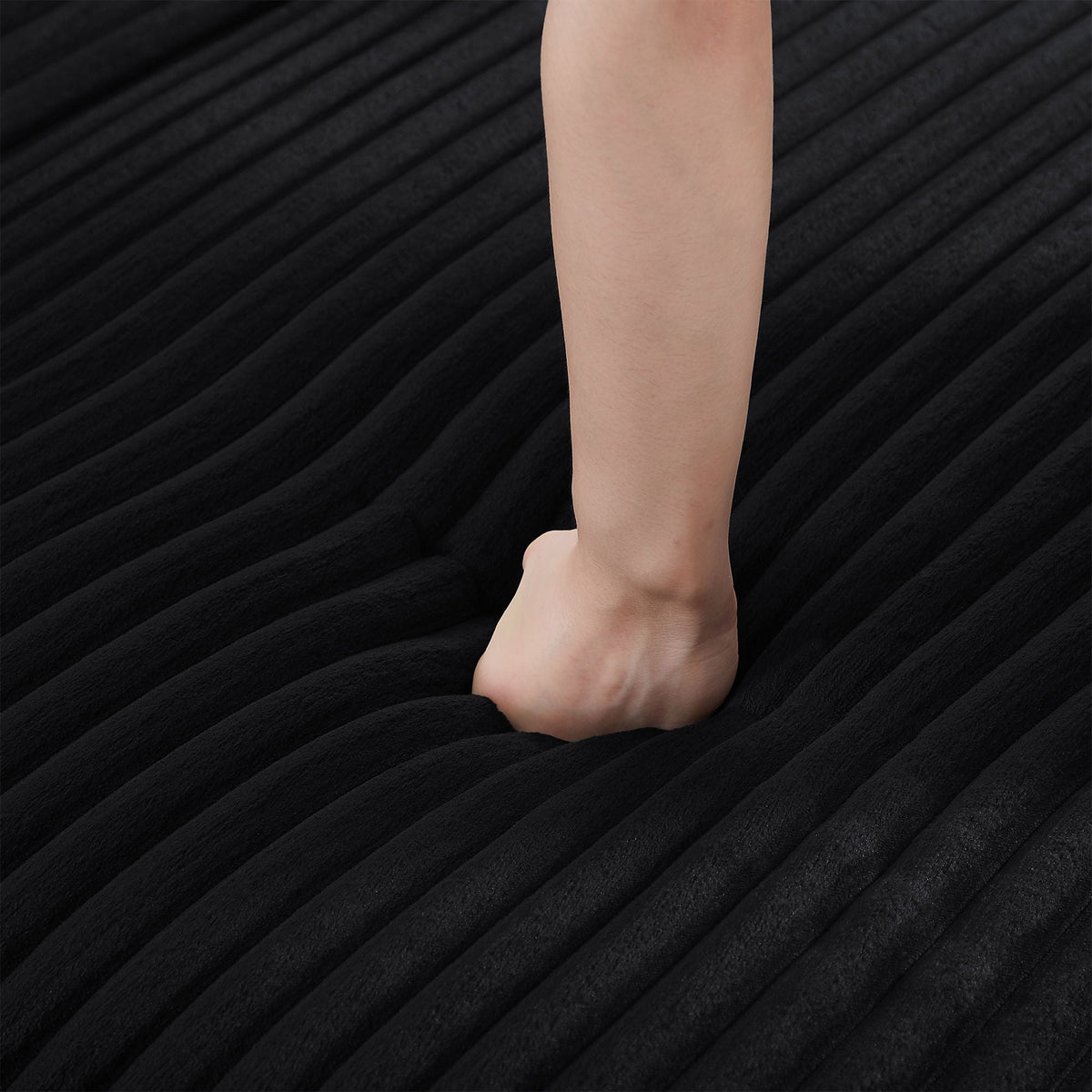Bare leg stepping on a black textured striped carpet on Tampa Home & Garden Store