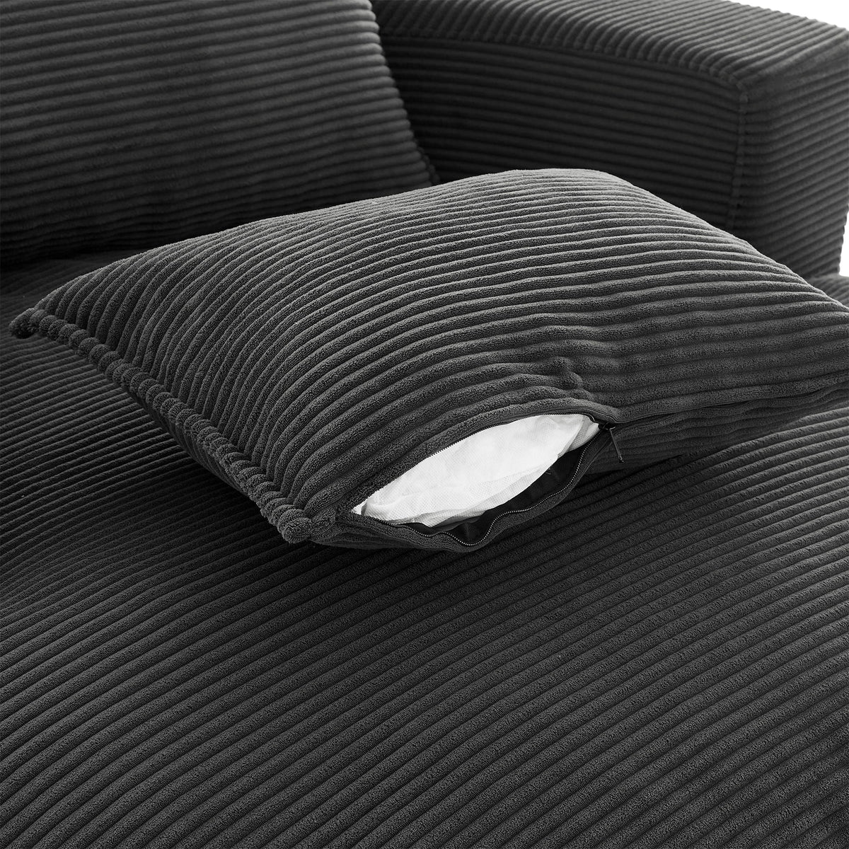 Swivel barrel chair with dark gray corduroy cushions and a white pillow on Tampa Home & Garden Store