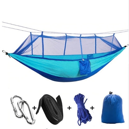 Blue parachute hammock with mosquito net, camping setup; includes carabiners and carry bag on Tampa Home & Garden Store