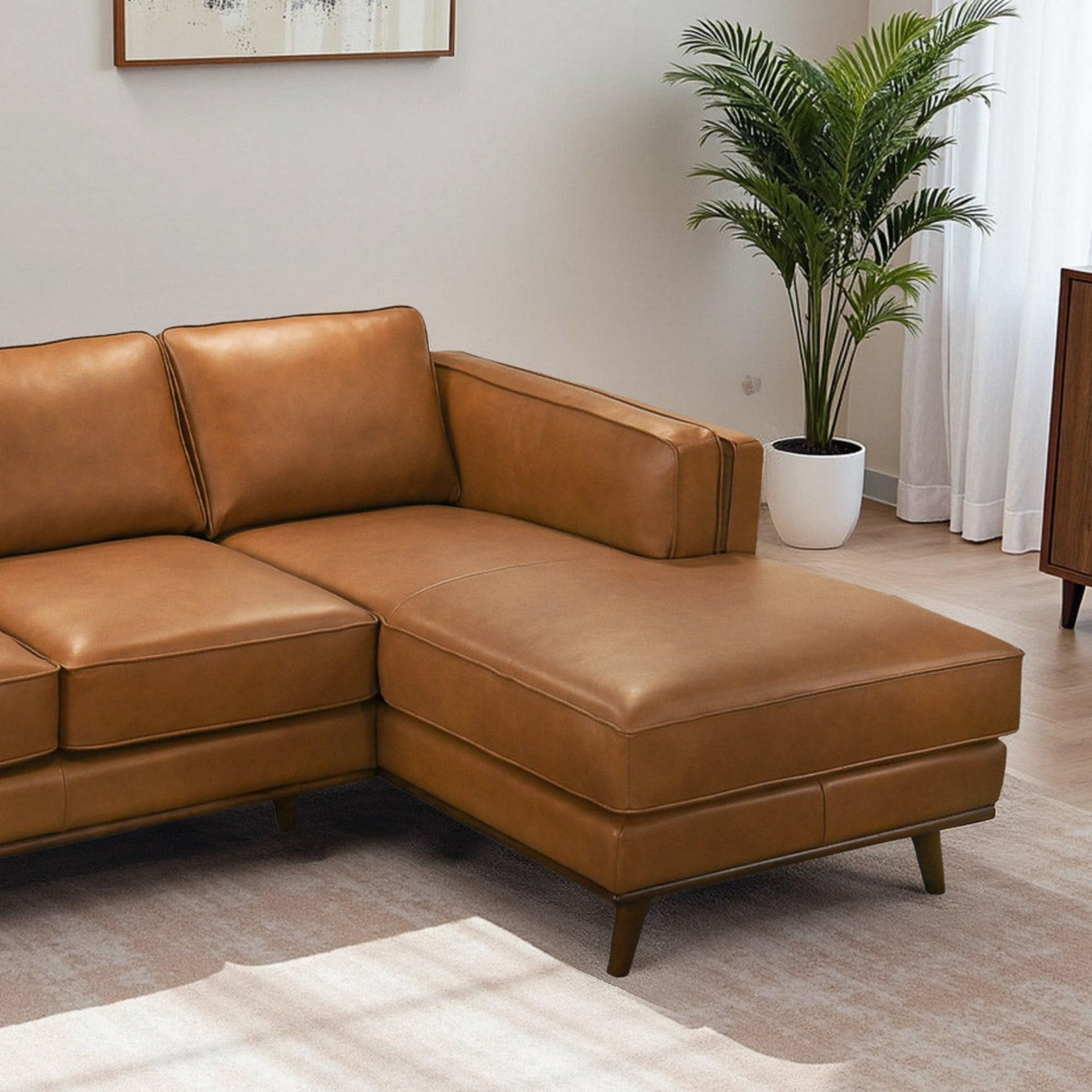 Chase sectional sofa tan leather with chaise and wooden legs in living room on Tampa Home & Garden Store
