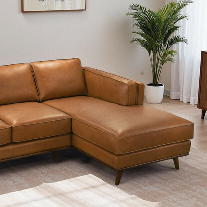 Chase sectional sofa tan leather with chaise and wooden legs in living room on Tampa Home & Garden Store