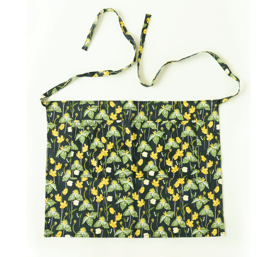 Gardener's Half Apron by Womanswork, dark navy floral with green leaves and yellow flowers on Tampa Home & Garden Store