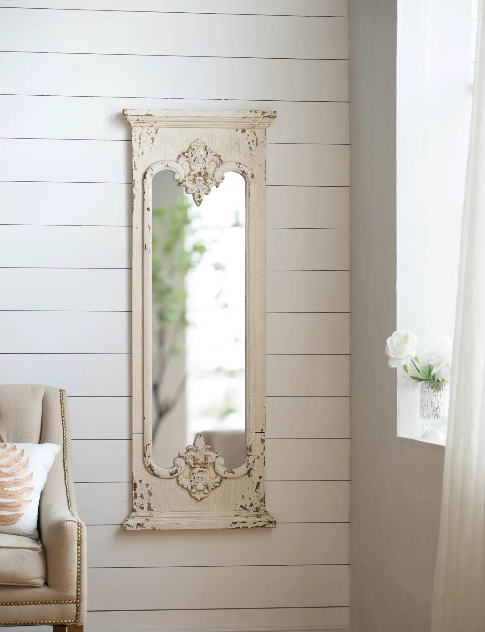 Full length mirror with distressed white solid wood frame and ornate floral motifs on Tampa Home & Garden Store