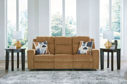 Kanlow reclining sofa in warm caramel fabric with two geometric-pattern pillows on Tampa Home & Garden Store