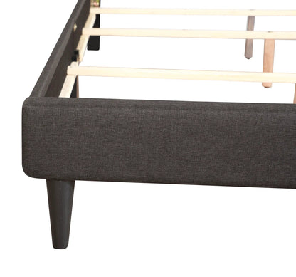 Button tufted upholstered bed in dark charcoal fabric with light wood slats and tapered legs on Tampa Home & Garden Store