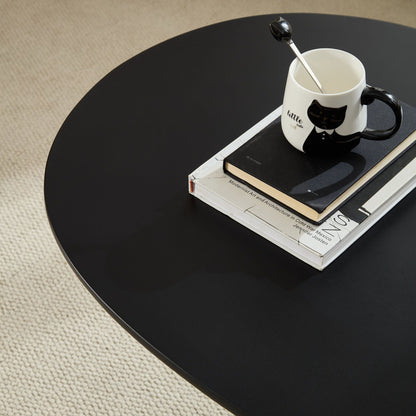 Lucky Stone Shaped End Table with Sculptural Base, black finish, white cat mug and stacked books on Tampa Home & Garden Store