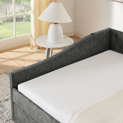 Upholstered daybed in dark gray fabric with nailhead trim and white mattress on Tampa Home & Garden Store