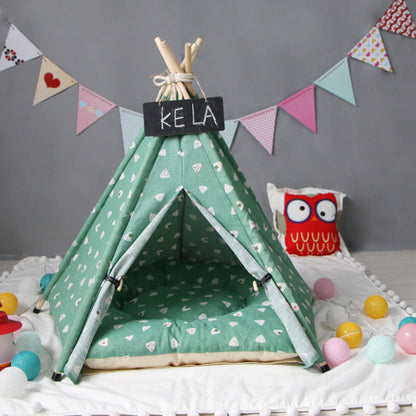 Pet tent kennel in teal fabric, teepee style with beige cushion and KELA sign on Tampa Home & Garden Store