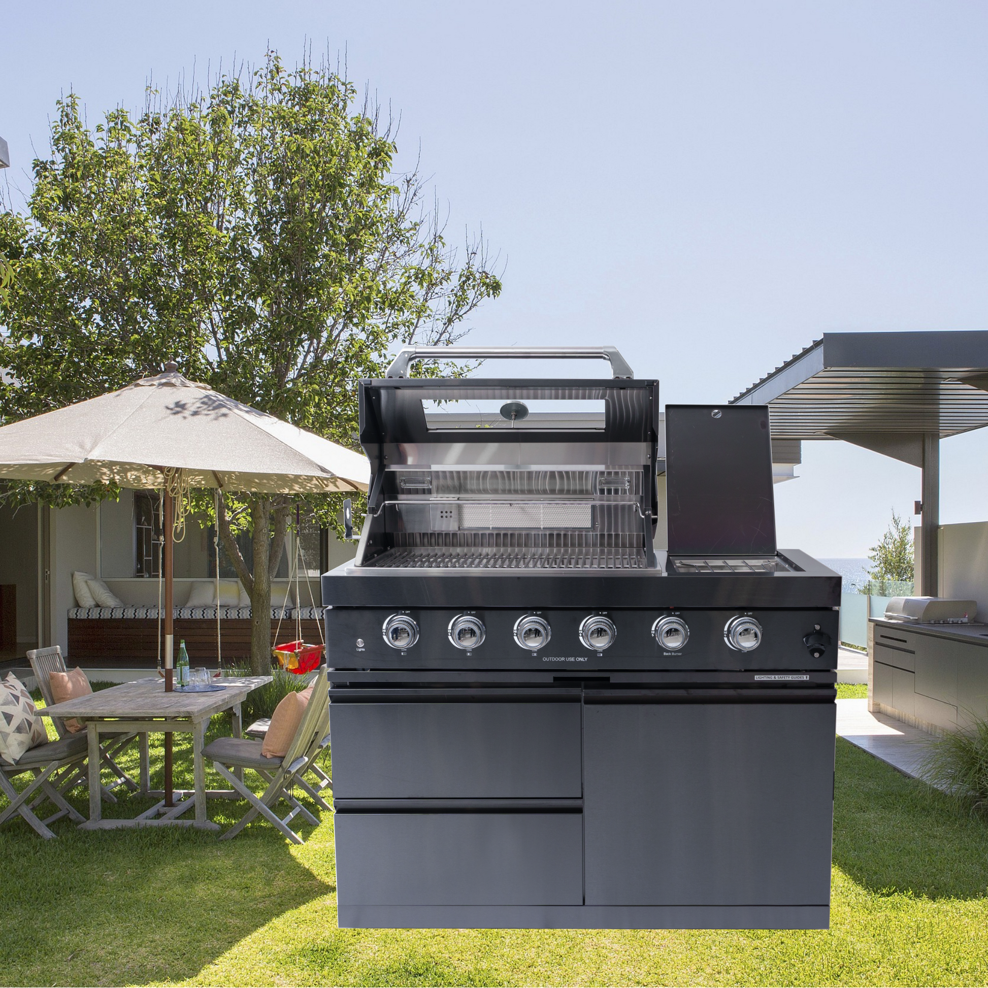 Black four-burner gas grill by HouseOfZazla with chrome accents outdoors on Tampa Home & Garden Store