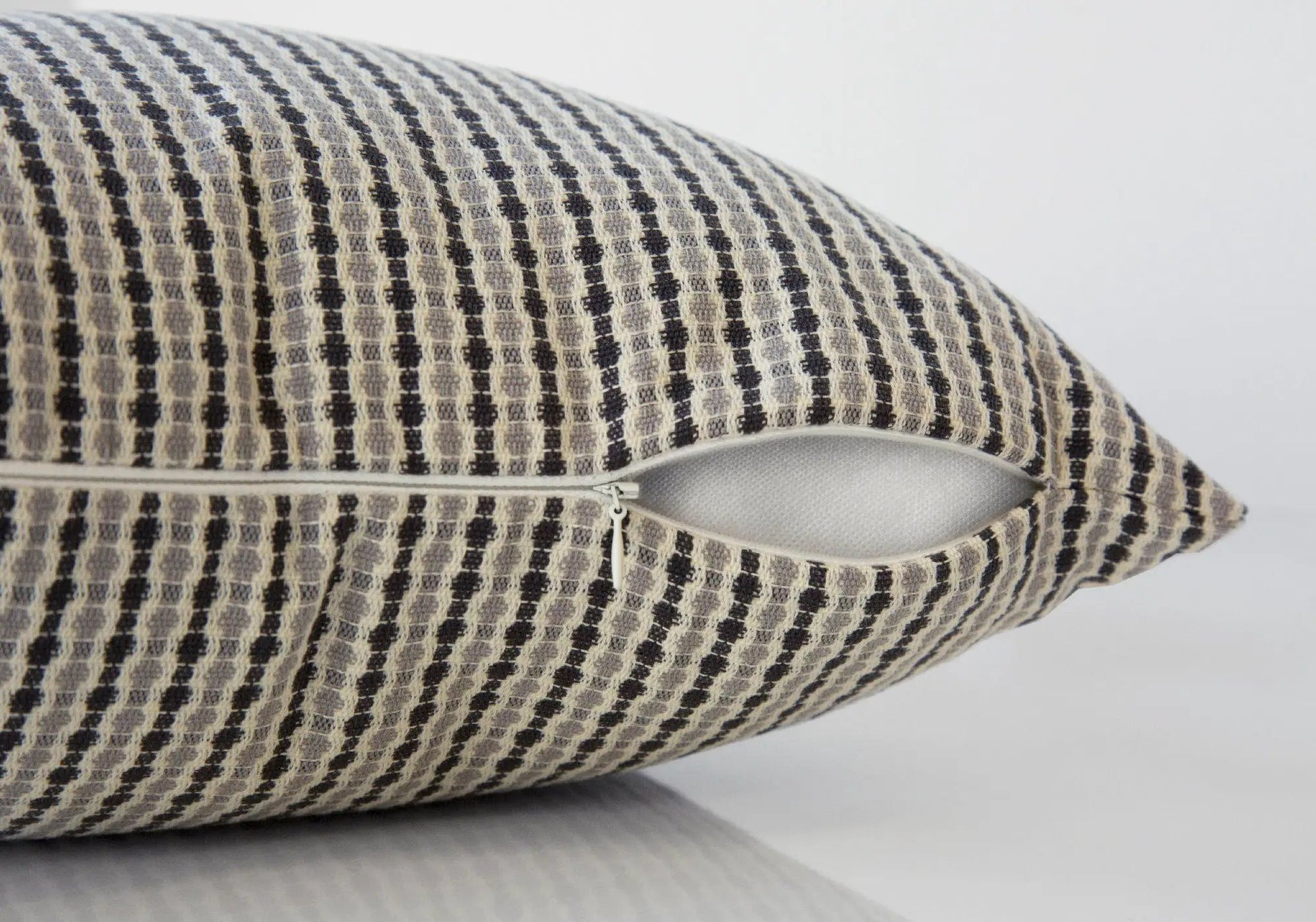Square throw pillow with black and ivory geometric weave; zipper closure; insert included on Tampa Home & Garden Store