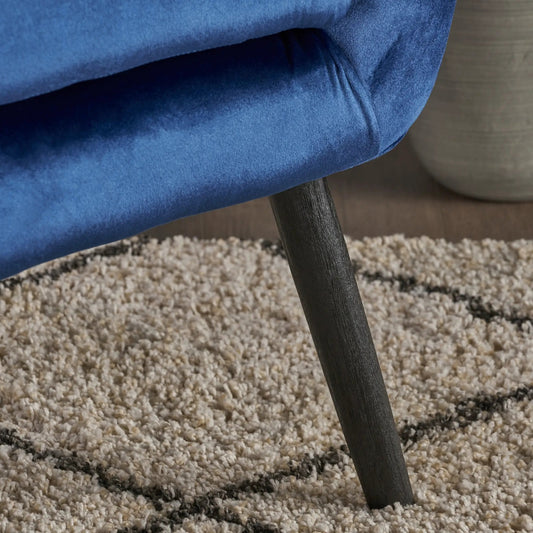 Navy velvet arm chair closeup with plush backrest and dark wooden leg, contemporary armchairs on Tampa Home & Garden Store