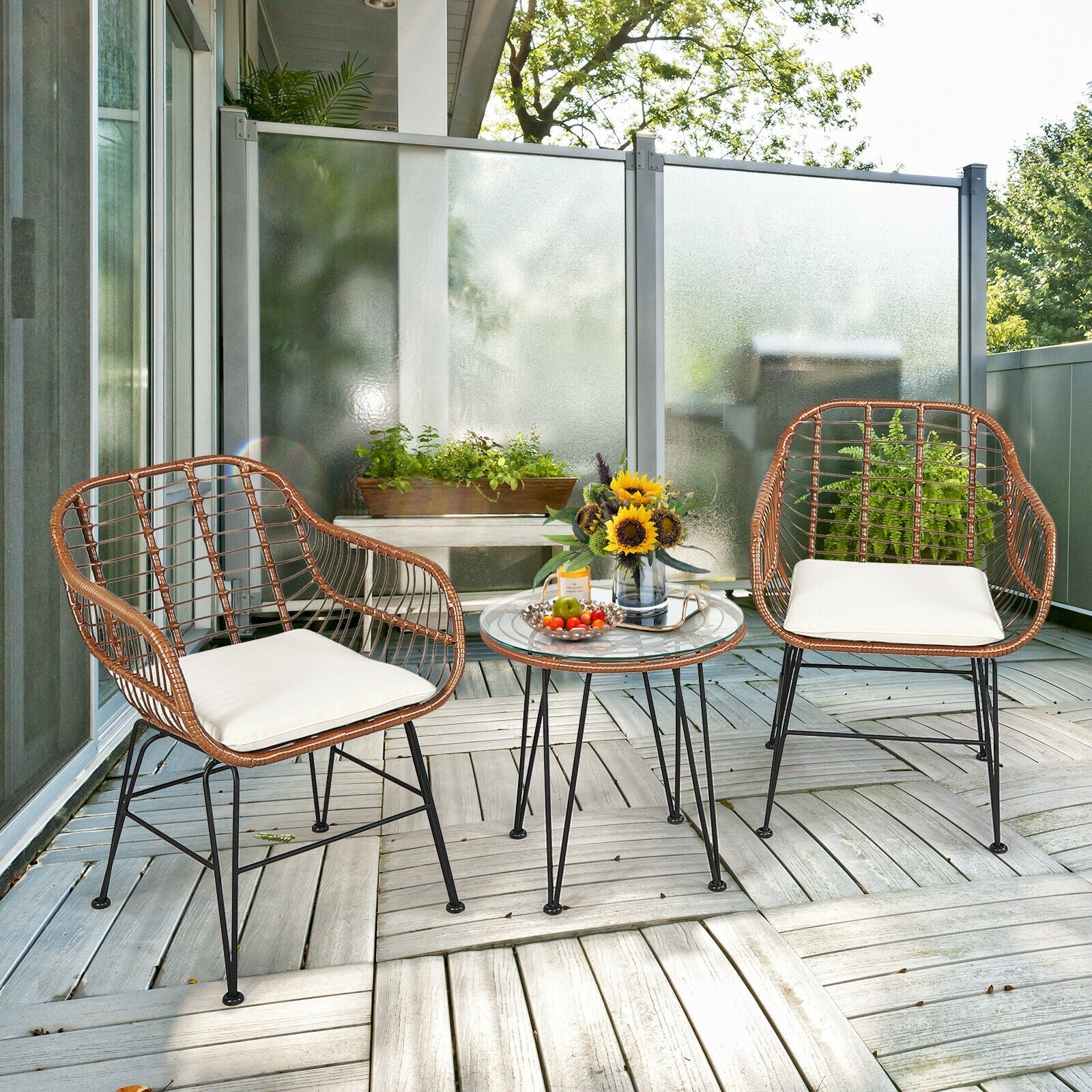 3-piece rattan patio bistro set with white cushions and glass table on a wooden deck on Tampa Home & Garden Store
