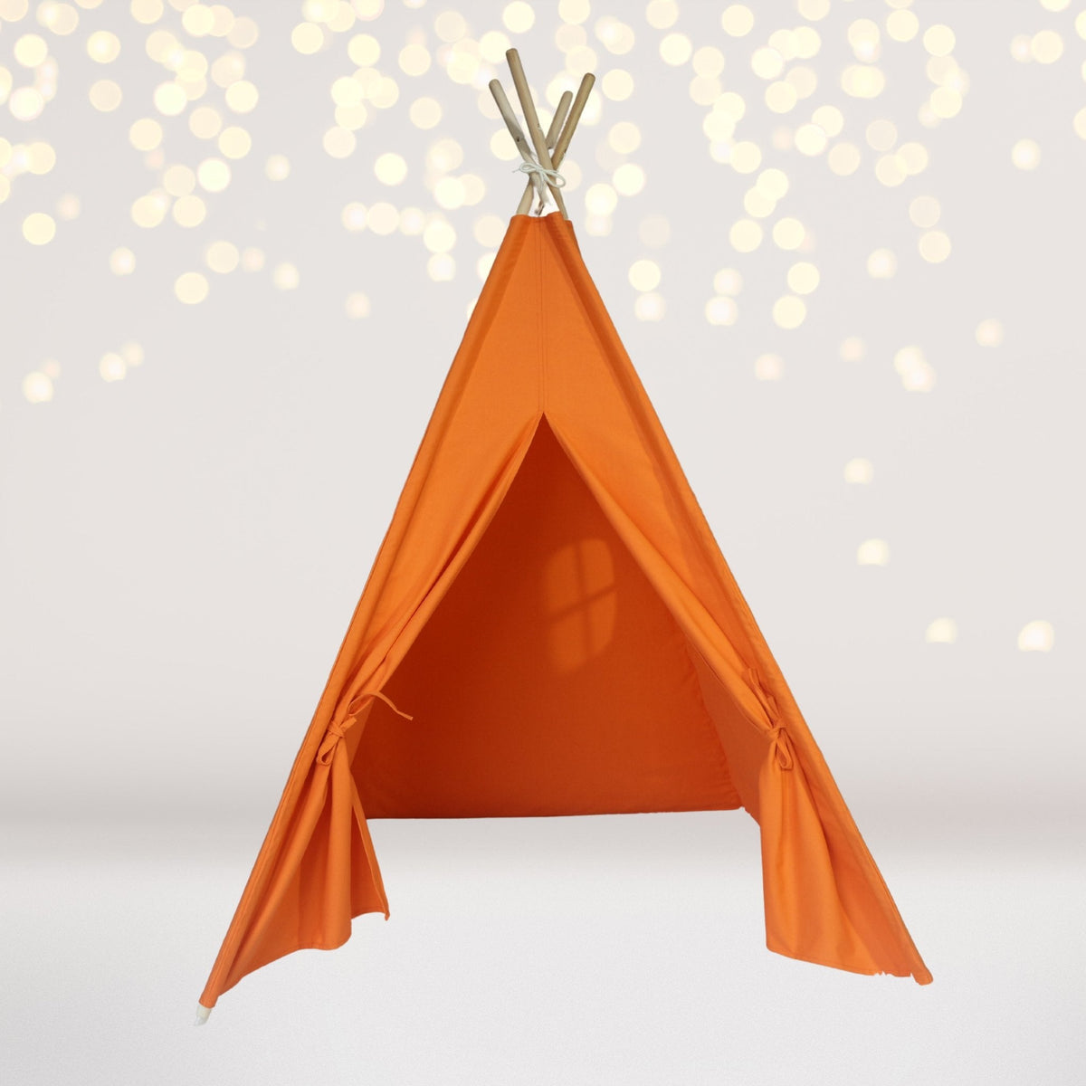Kids cotton teepee play tent with orange fabric and wooden poles, soft bokeh backdrop on Tampa Home & Garden Store