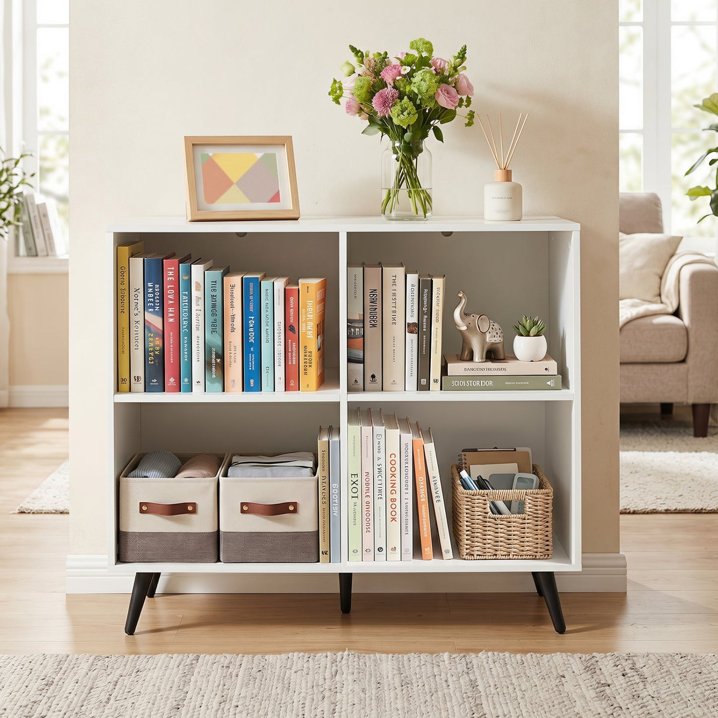 4-Cube White Bookcase with Metal Legs filled with books and storage bins in a bright living room on Tampa Home & Garden Store