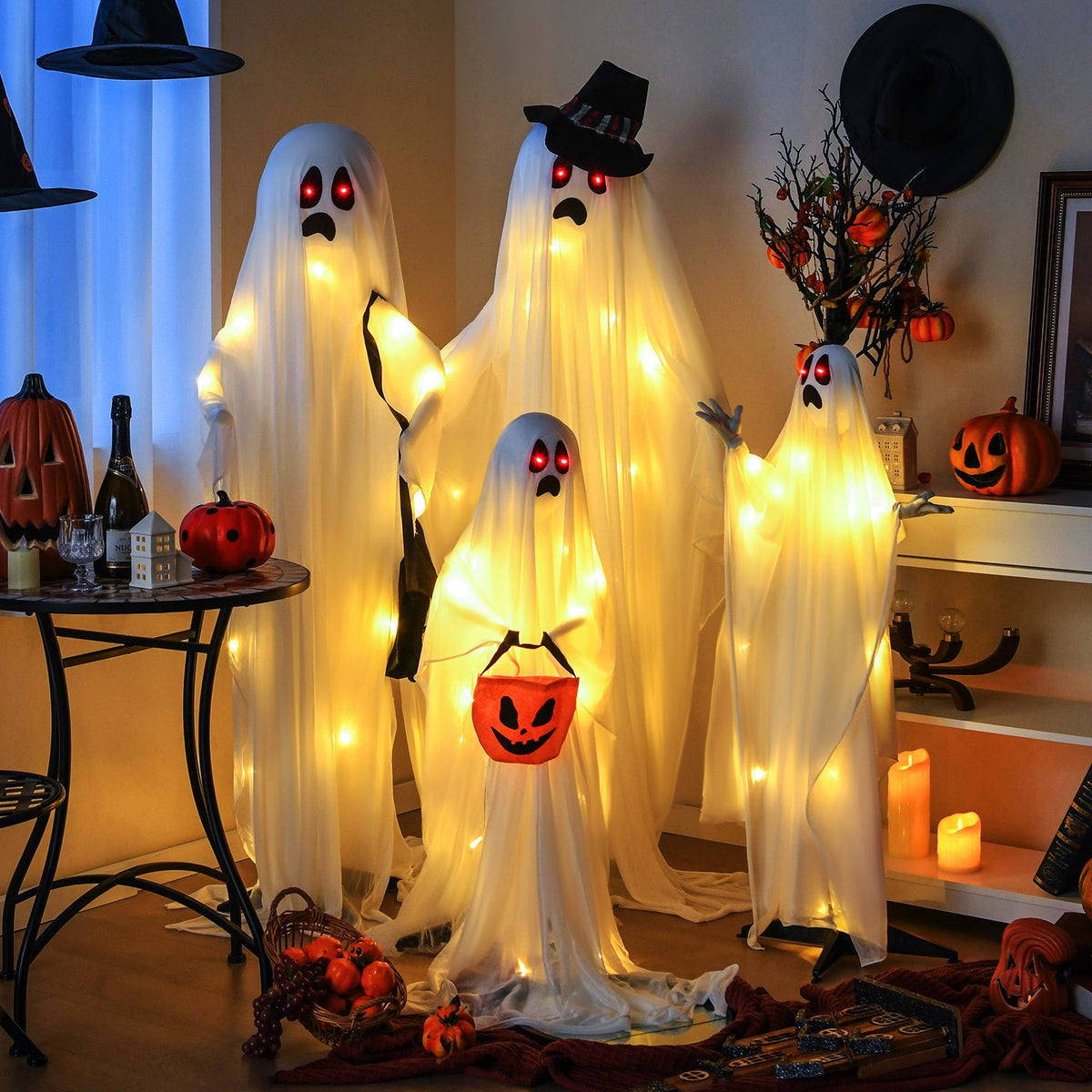 4-piece ghost family display with white fabric ghosts, red LED eyes, and warm white LEDs on Tampa Home & Garden Store