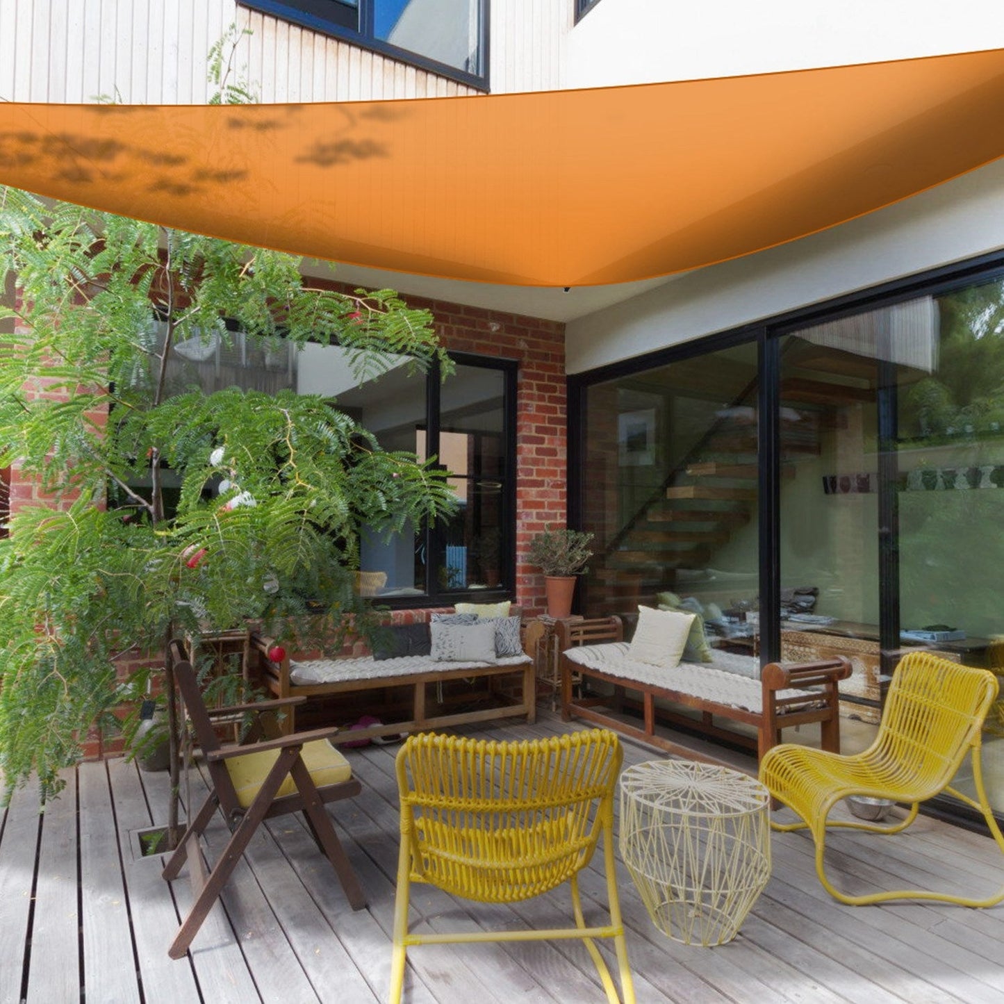 Shade sail triangle patio cover orange over a wooden deck with yellow chairs GemGear on Tampa Home & Garden Store