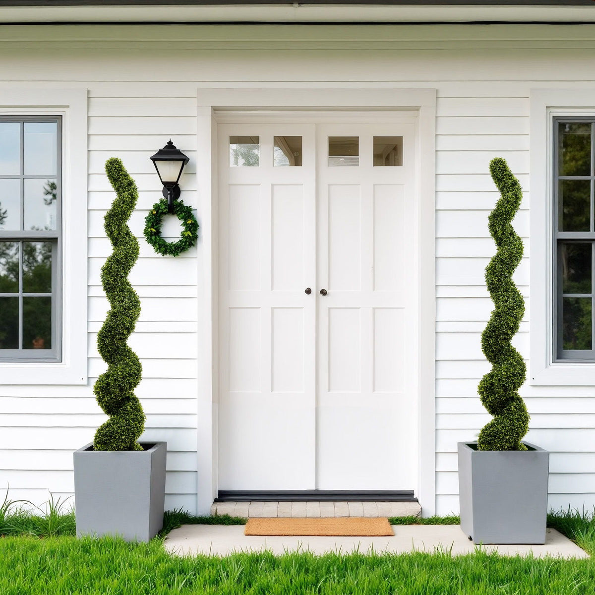 Artificial UV resistant boxwood spiral topiary, green, HouseOfZazla, pair in pots by a white door on Tampa Home & Garden Store