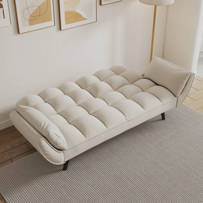 Futon sofa with tufted cream cushions and two padded armrests in a bright living room on Tampa Home & Garden Store