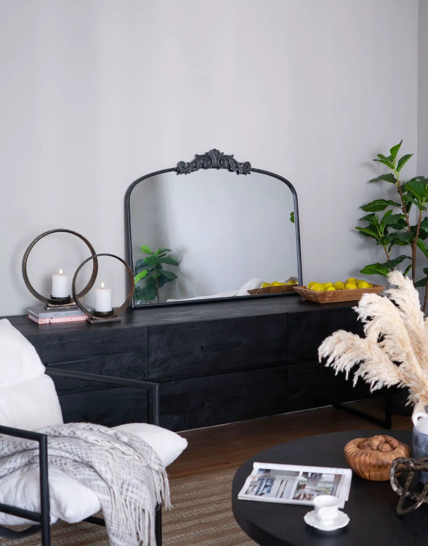 Arch Mirror with black ornate crest frame on dark wood dresser, candles and plants nearby on Tampa Home & Garden Store