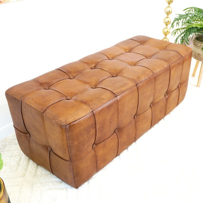 Tan leather upholstered bench with button-tufted surface on Tampa Home & Garden Store