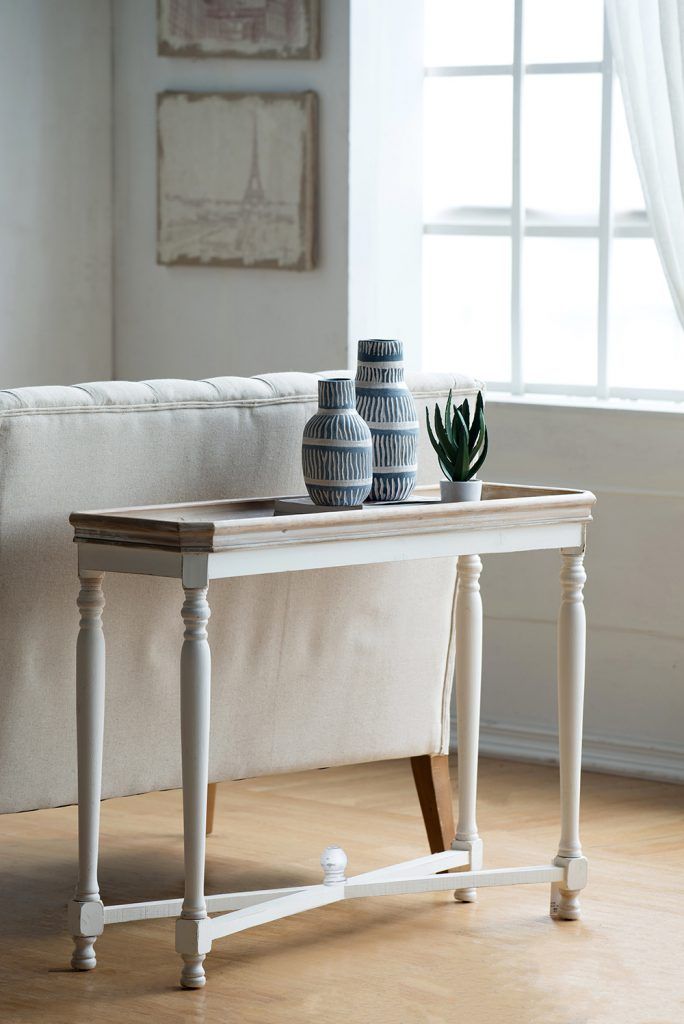 Alcott narrow side table, brown fir wood with white legs, topped with blue vases and a plant on Tampa Home & Garden Store