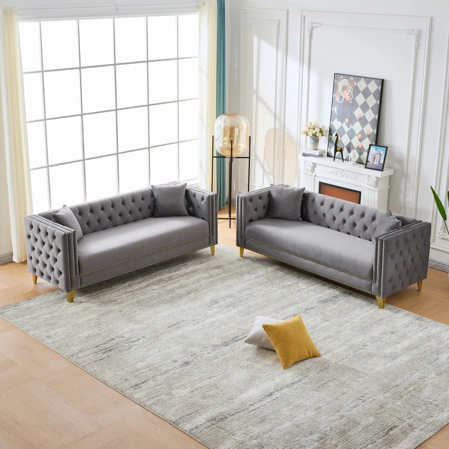 Pair of deep-seat gray sofas with button tufting, square arms, and nailhead trim on Tampa Home & Garden Store