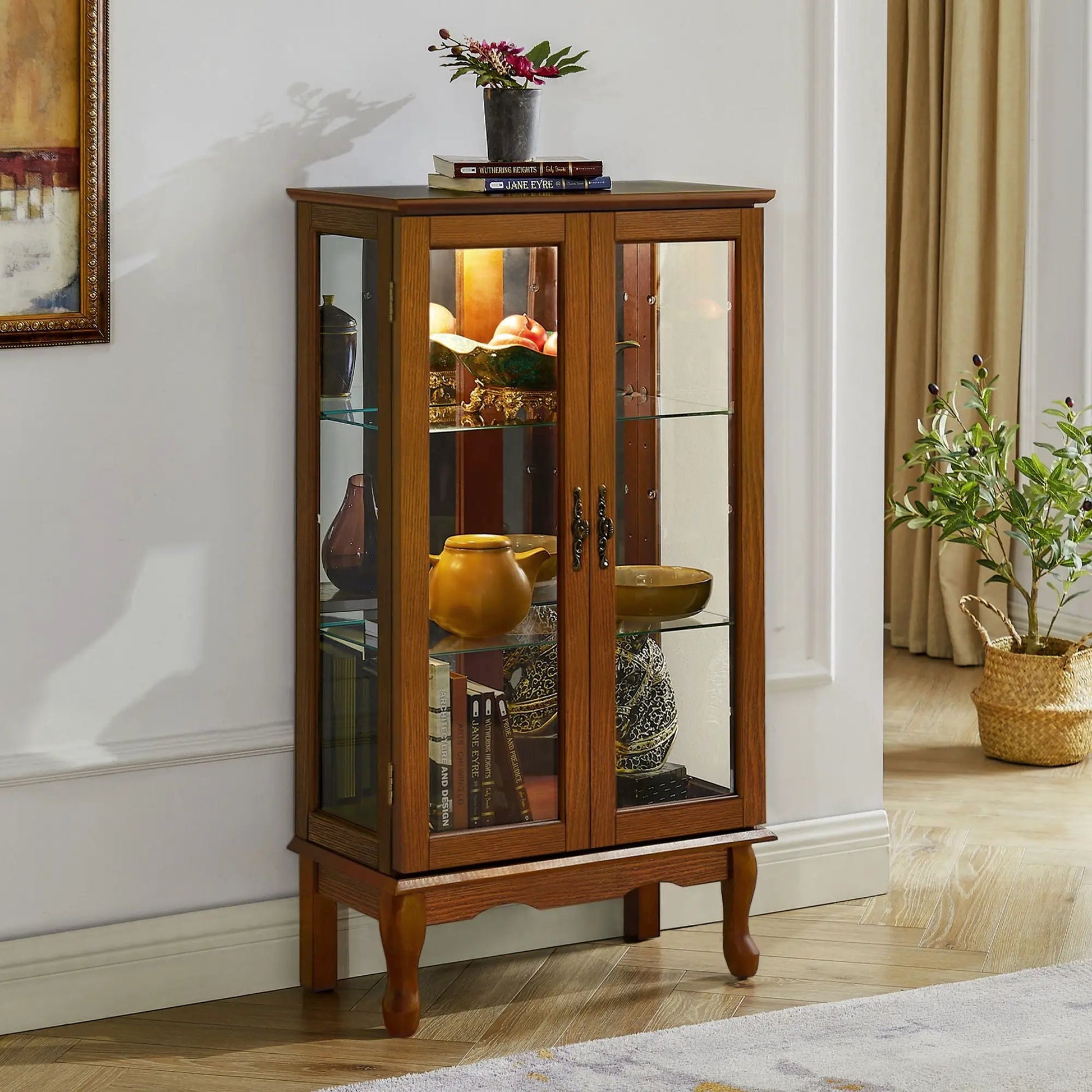 Curio cabinet in wood finish with glass doors, 3 tiers, mirrored back, top vase and books on Tampa Home & Garden Store