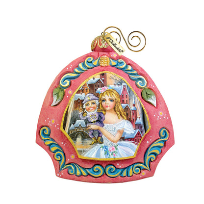 Nutcracker sculpted ornament by G. DeBrekht with pink arch frame and village scene on Tampa Home & Garden Store