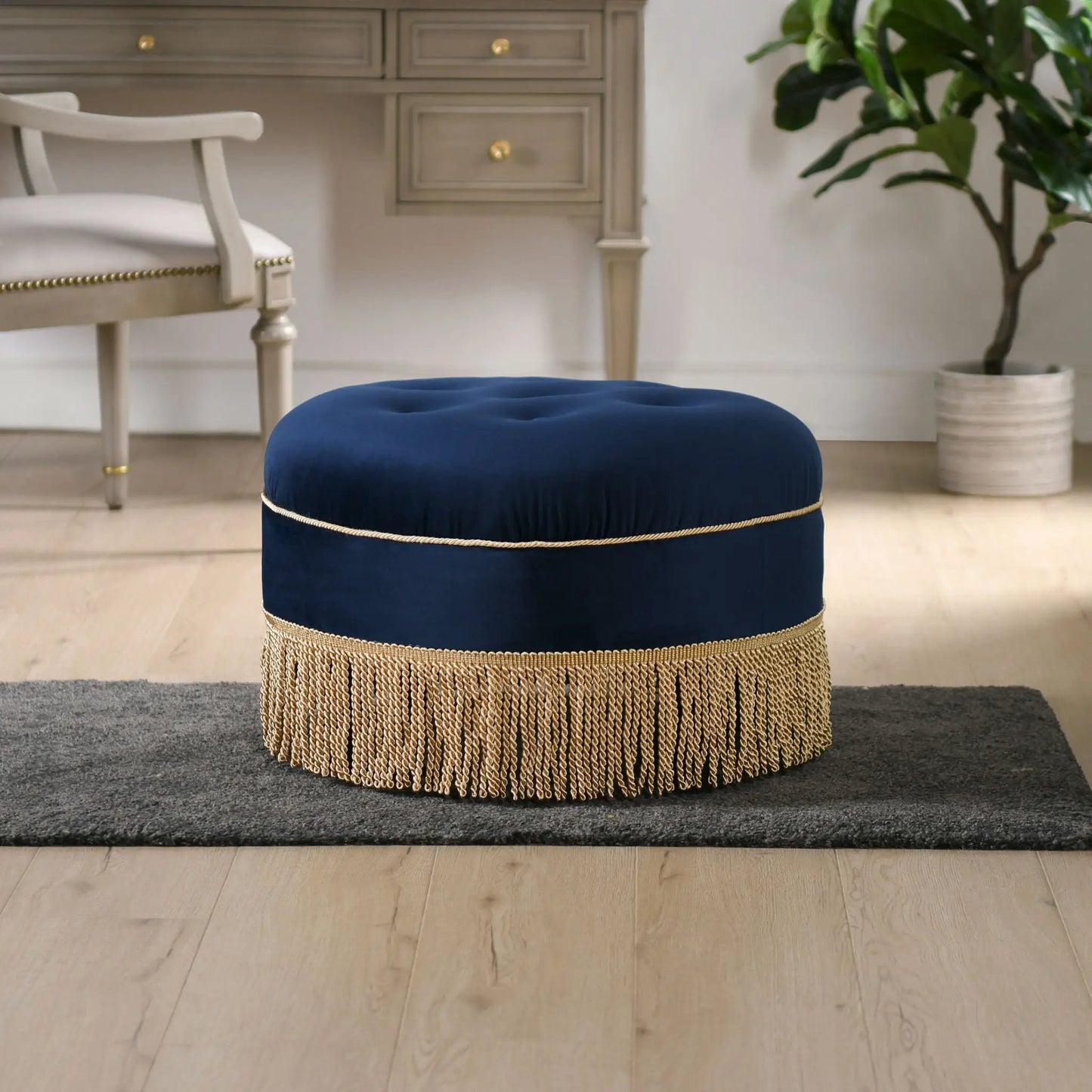 Yolanda round upholstered accent ottoman in navy blue velvet with gold fringe trim on Tampa Home & Garden Store