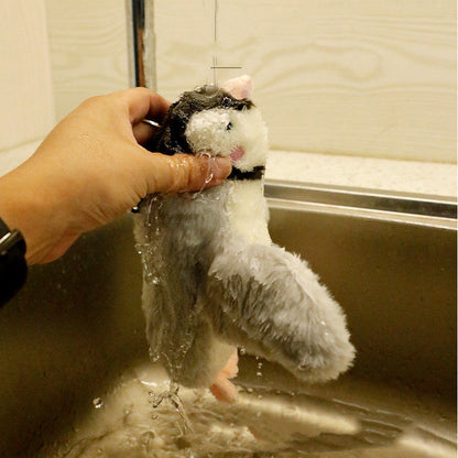 Pet plush toy gray and white winged fish-bird Sell My Stuff being rinsed under water on Tampa Home & Garden Store