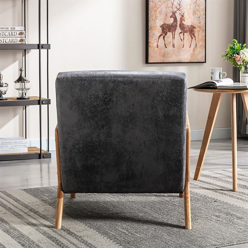 Classic mid-century modern open-framed arm chair with charcoal cushions and light wood legs on Tampa Home & Garden Store