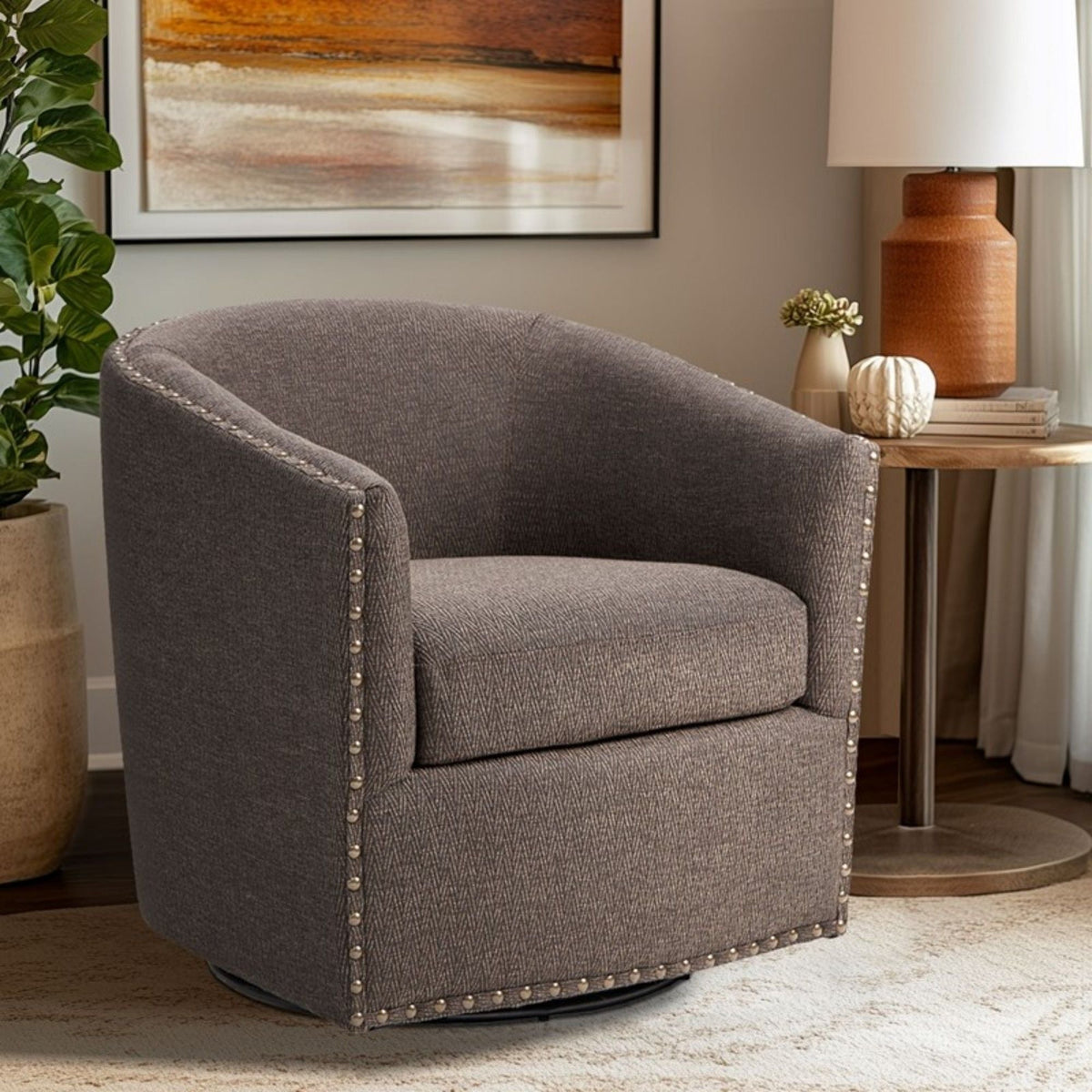 Luxurious pearl silver swivel chair with nailhead trim and 360-degree rotation in a space on Tampa Home & Garden Store