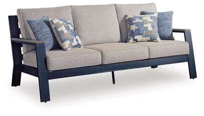 East Beach sofa with beige upholstery and dark navy frame, blue patterned cushions on Tampa Home & Garden Store