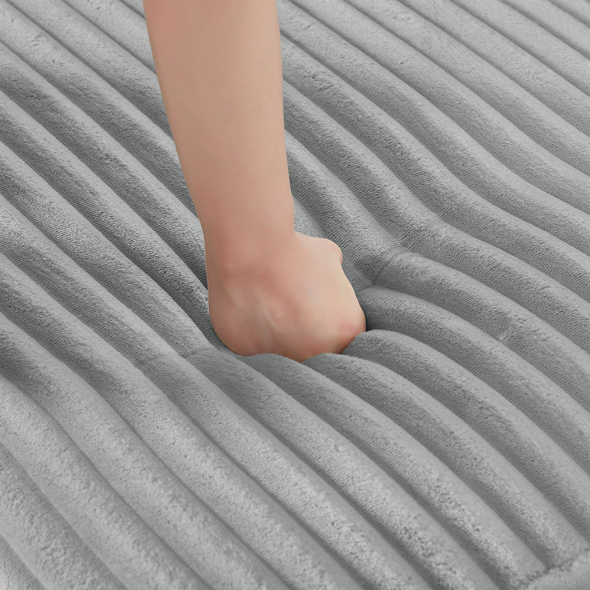 Bare foot on gray plush fabric with diagonal ribbed texture on Tampa Home & Garden Store