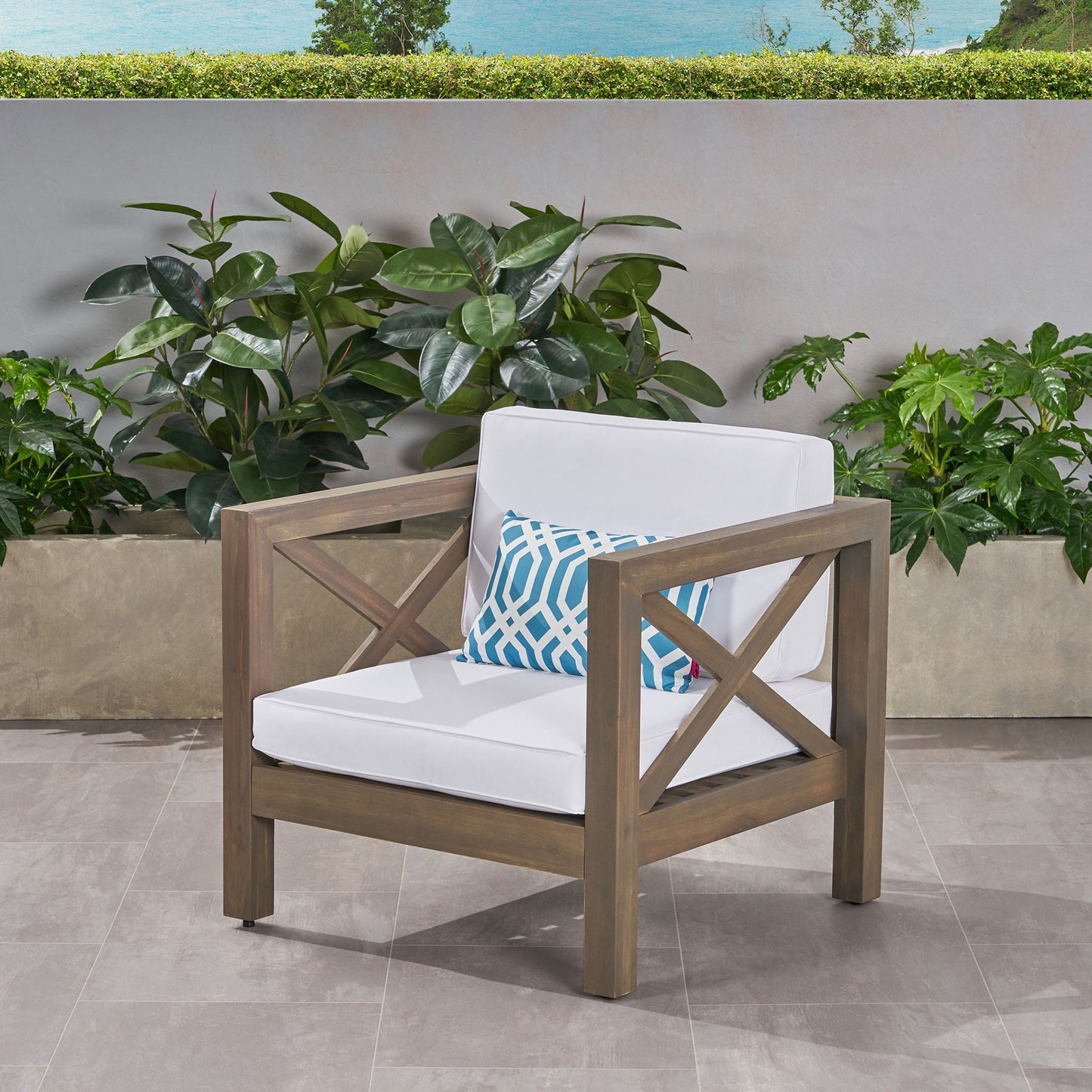 Brava mid-century outdoor club chair with water resistant white cushions and blue pillows on Tampa Home & Garden Store