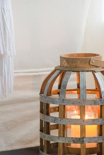 Decorative wooden lantern with metal bands and carrying handle, candlelit indoors on Tampa Home & Garden Store