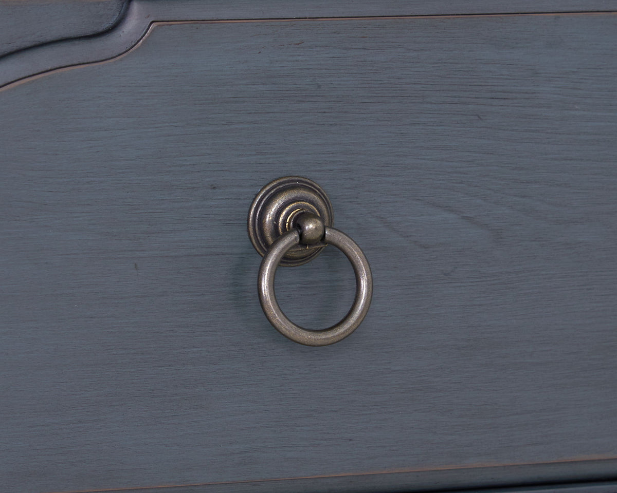Blue accent chest with round metal ring pull on blue wood surface on Tampa Home & Garden Store